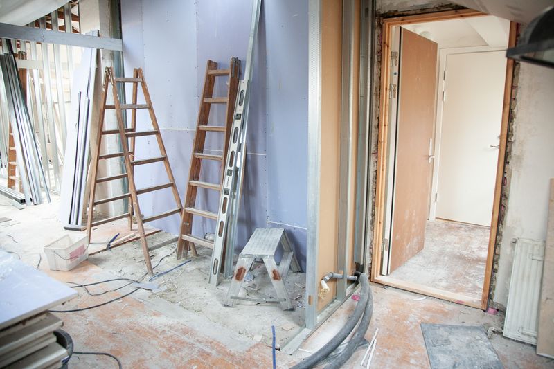 Room mid-renovation with dust and construction materials